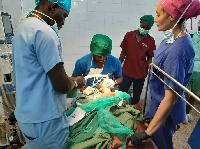 A team of Anaesthetists resuscitating a child after a major surgical operation