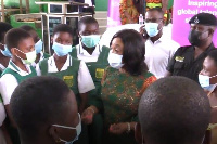 Minister Ayorkor Botchwey (right) confers with some female students at Anyaa-Sowutuom