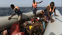 Migrants step over dead bodies while being rescued in the Mediterranean Sea, off the coast