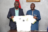 Vice President Dr. Mahamudu Bawumia receiving a Black Stars jersey