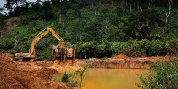 Excavator destroying the forest for mining