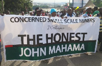 The Concerned Small Scale Miners Association marching with their banner