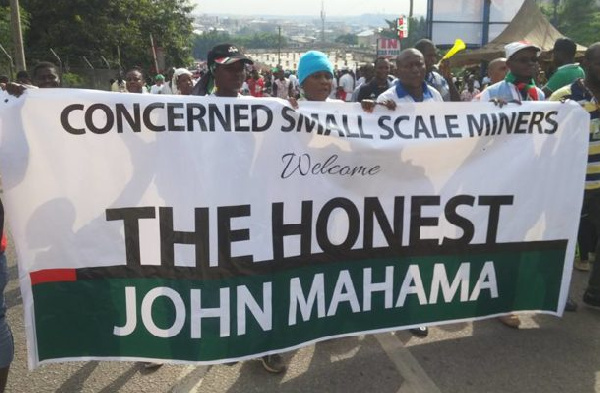 The Concerned Small Scale Miners Association marching with their banner