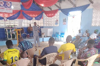 Reverend Alexander Yevu delivering a message to a congregation