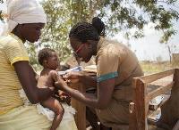 Community health nurse [R] discharging her duties