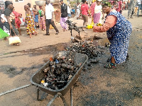 A trader cleaning filth from the gutter