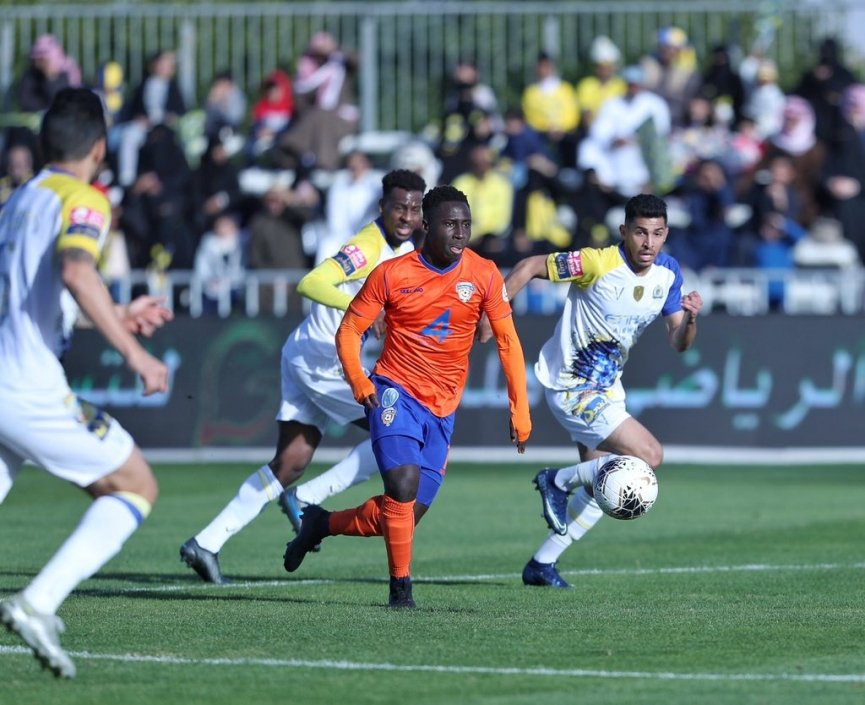 Samuel Owusu (in orange jersey) glides past opponents