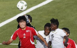 Jon Yun Sim of Korea DPR jumps for a header with Linda Amoako of Ghana.