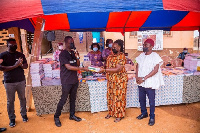 CEO of Dentsu Ghana, Andrew Ackah presenting the items to Joyce Nana Simmons, Headteacher