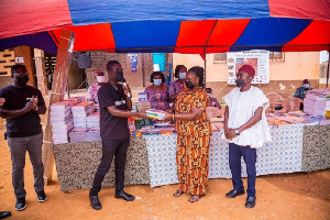 CEO of Dentsu Ghana, Andrew Ackah presenting the items to Joyce Nana Simmons, Headteacher