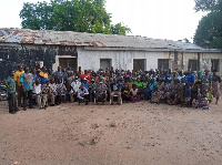 A group photograph taken after the community forum