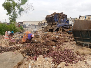 Some women sorting out rotten onions for good ones