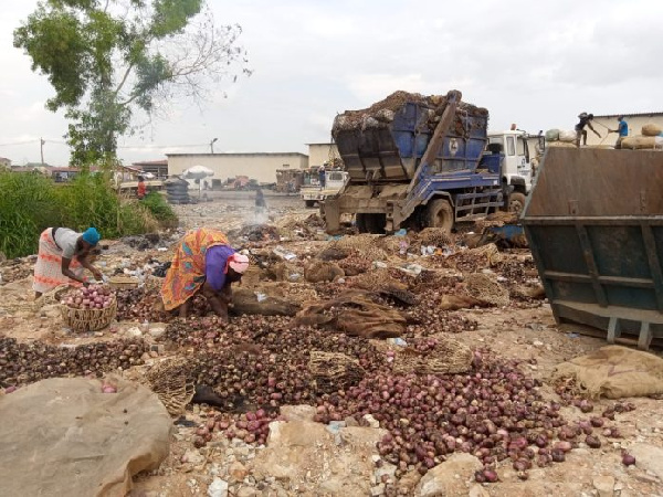 Some women sorting out rotten onions for good ones