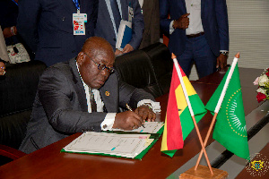 President Akufo-Addo appending his signature to the Treaties.