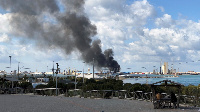 A smoke rises from a port of Tripoli after being attacked in Tripoli