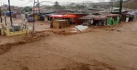 Objects including vehicles were seen being washed away