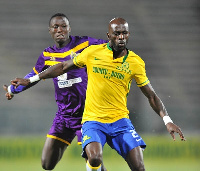 Anthony Laffor of Mamelodi Sundowns challenged by Daniel Amoah of Medeama