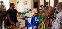 Osie Adza Tekpor (2nd left) receiving the items from Miss Amu (3rd right) and Asafoatse Korkor