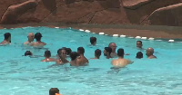 Tourists and local residents cool off in the Oasiria swimming pool