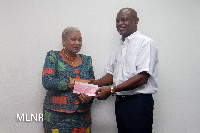 Joyce Aryee receiving donation from Togbe Afede