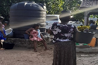 Residents waiting to fetch water from the Minister's house