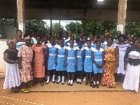 Students and parents posing with officials of the school