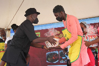 CEO of Global Media Alliance presenting a hamper to winners of the competition, Kasoa Zongo