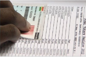 File photo: A voter's name being checked in the register