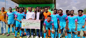 Basake Holy Stars FC receives a cheque from a benevolent group