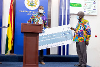 General Manager of Wilmar Limited, Kwame Wiafe presenting the cheque to Yaw Osafo-Maafo