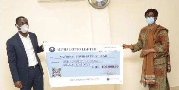 Chairperson of the Trust Fund, CJ Sophia Akuffo (Retd) receiving the cheque from CEO of Alpha Lotto