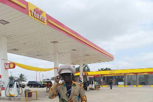 Highlife musician  Kojo Antwi  standing in front of the filling station