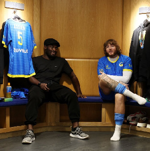 Michael Essien (left) and a friend at the Chelsea dressing room