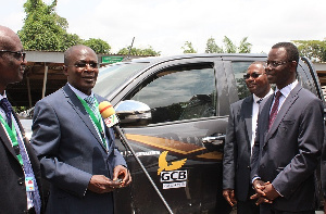 Professor Obiri Danso, receiving the key, Mr. Samuel Sarpong, Chief Operating Officer of GCB