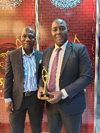 Executive Assistant Manager of the Hotel, David Eduaful (right) with the award