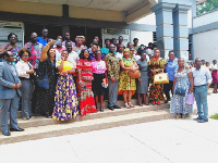 Members of the organisation in a group photograph with some teachers and students