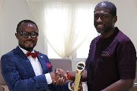 Mr Ernest De-Graft Egyir (L) presented the award to Mr. Kevin Okyere (R)