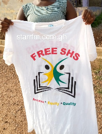 A student holding a branded FSHS T-shirt