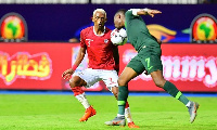 Madagascar's forward Charles Andriamahitsinoro (L) vies for the ball with Nigeria's Ahmed Musa