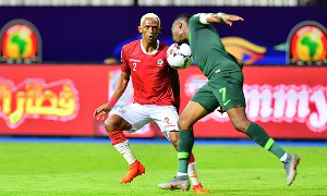 Madagascar's forward Charles Andriamahitsinoro (L) vies for the ball with Nigeria's Ahmed Musa