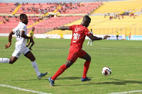 An Aduana Stars player chases a Kotoko player for the ball