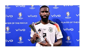 Real Madrid’s Antonio Rudiger poses with his MoM trophy after Germany’s win over Denmark