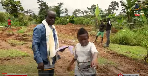 Yaw Dabo (in white) being shown around the land