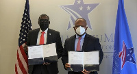 Mahmoud Bah (L) with Alain Ebobissé (R) after signing the MoU