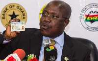 NIA Boss, Professor Ken Attafuah holding a Ghana Card