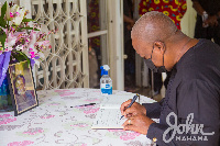 Former President, John Dramani Mahama signing the book of condolence