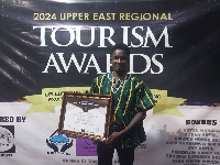 Moses Apiah poses with his citation on the awards night