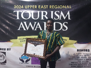 Moses Apiah poses with his citation on the awards night