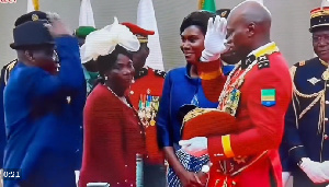 General Oligui Nguema salutes his father as mother and wife look on