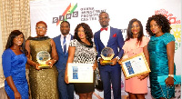 Management of GLICO displaying their awards